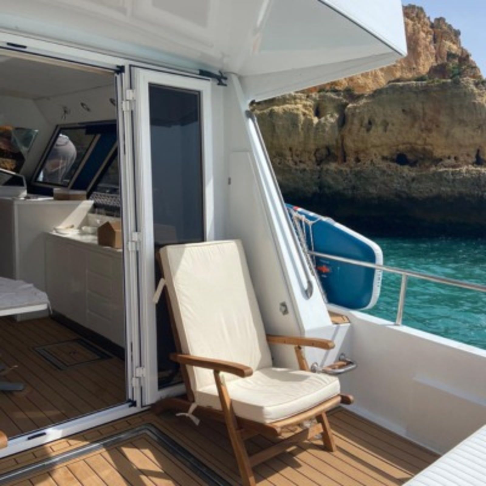 The aft deck of Julieta with the Algarve cliffs behind.